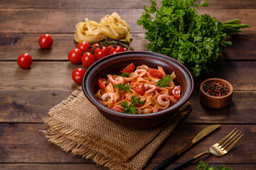 Fettuccine pasta with shrimp, cherry tomatoes, sauce, spices and herbs