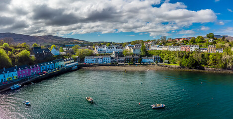 Naklejka premium A panorama aerial view from offshore towards Portree on the Isle of Skye, Scotland on a summers day