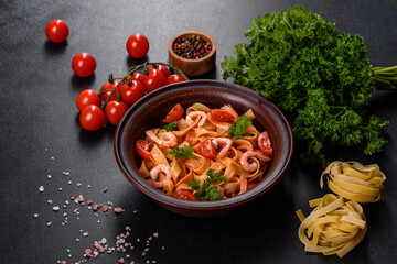 Fettuccine pasta with shrimp, cherry tomatoes, sauce, spices and herbs
