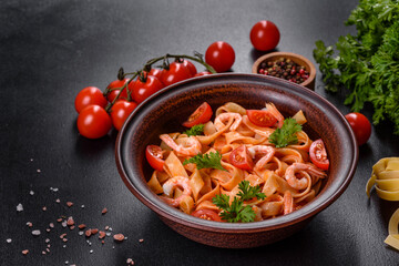 Fettuccine pasta with shrimp, cherry tomatoes, sauce, spices and herbs