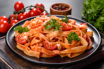 Fettuccine pasta with shrimp, cherry tomatoes, sauce, spices and herbs