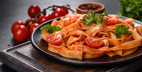 Fettuccine pasta with shrimp, cherry tomatoes, sauce, spices and herbs