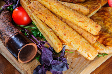 Traditional Georgian adjara khachapuri and Kolkh khachapuri on the table. Assorted Georgean bread.