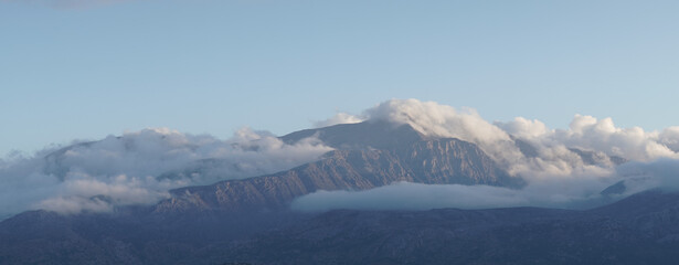 Fototapeta premium Lasithi Plateau mountain landscapes with cloudy sky on Crete Island in Greece.