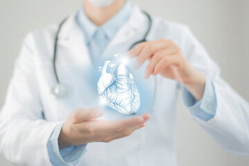 Unrecognizable doctor holding highlighted handrawn Heart in hands. Medical illustration, template,...