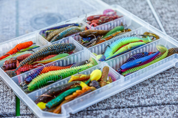 Fishing tackles and fishing baits in box .Classic Colored Fishing Lure , Beautiful Background digital image.Fishing on the lake at sunset. Fishing background