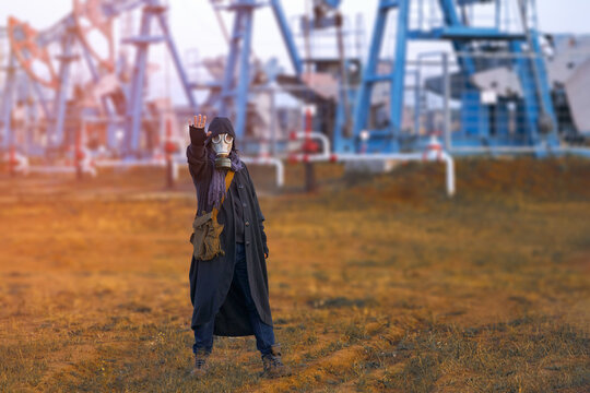 A Man With An Outstretched Hand In A Gas Mask Against The Background Of Oil Pumping Machines. The Surrounding Situation Is Gloomy, Foreshadowing The Inevitability Of A Catastrophe.