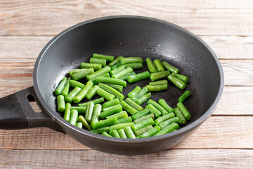 Green beans in a skillet for preparing green beans salad. Step by step recipe.