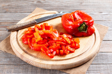 Sliced red peppers on a cutting board for making lentil soup. Step by step.