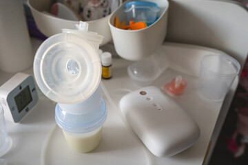 Electric Breast Pump Breastfeeding Machine and bottle with milk top view