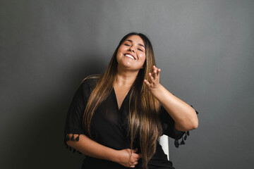 portrait of tender, happy and relaxed overweight latin young woman