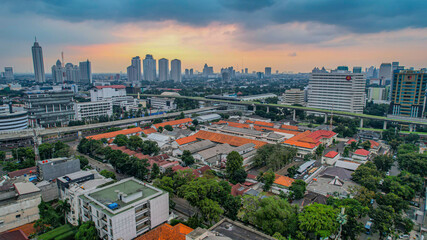 Aerial view of articulated city buses arriving and leaving at bus station near main railway station MRT line at Kebayoran Baru. Jakarta, Indonesia, Agustus 5, 2021