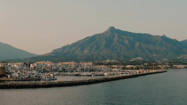 Aerial drone helicopter panoramic view of Puerto Banus Marbella marina luxury port in Spain at sunset