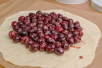 Summer galette with cherries on brown concrete background