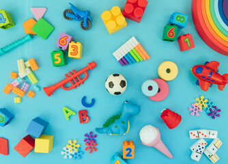 Background with different wooden and plastic kids toys with copy space