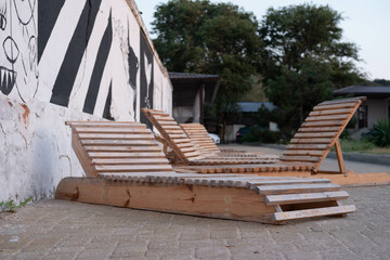 Empty sun loungers for the beach on the stone walkway in the hotel