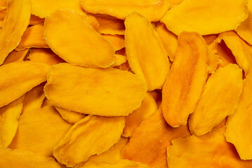 Dry sugar mango slices as a background.