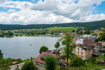 Fototapeta na wymiar View of Le Pont, a beautiful small village directly situated at Lac de Joux in the Swiss Jura mountains
