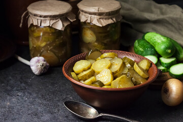 Pickled cucumber salad in a bowl and jars