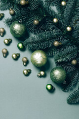 Background with Christmas decorations on a dark green background. Christmas tree, golden toys. Place for text