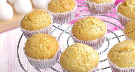 Selective focus. classic homemade muffins are cooled on a wire rack to cool. Fresh vanilla cupcakes close up. Vanilla baked goods. High quality photo