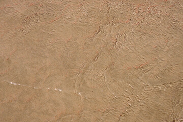 Surface of clear water on tropical sandy beach in Crete Greece.