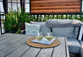Sheltered outdoor covered deck for relaxing summer afternoon and evenings with glass or wine during...