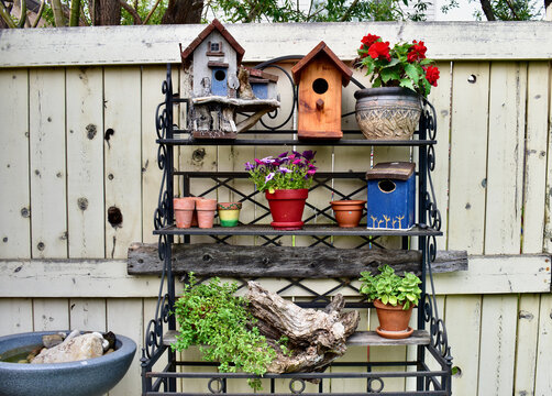 Backyard artistic arrangement of wooden painted birdhouses on garden potting bench, outdoor lifestyle gardening with rustic decor