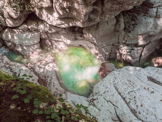 A seething clear light green river flowing in a gorge between relief canyons. Magnificent southern nature
