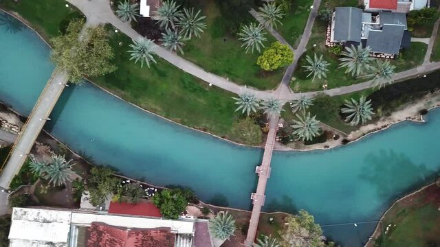 Aerial view flyover kibbutz Nir David, North of Israel. A view of farmland close to Beit shean valley with river channel dividing east and west side and Small Town With Red rooftops.