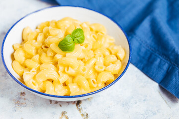 Mac and cheese on a white rustic board