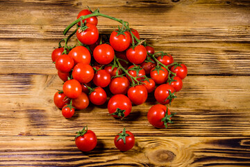 Heap of small cherry tomatoes on wooden table