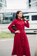 Beautiful stylish woman touching her hair by hand outdoors