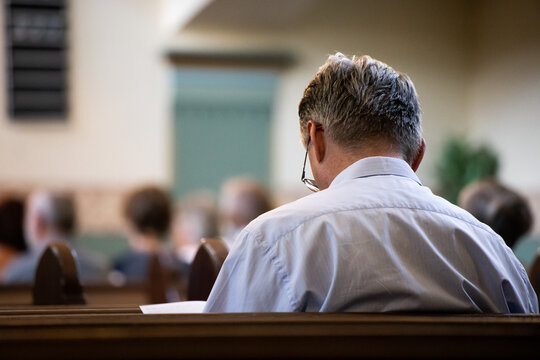 A person reading a bible in church.