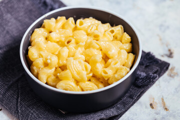 Mac and cheese baked in oven with basil leaves