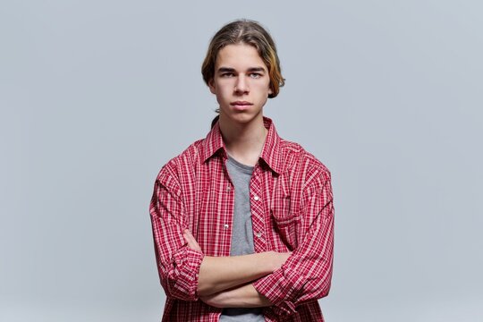 Portrait of serious guy teenager with crossed arms