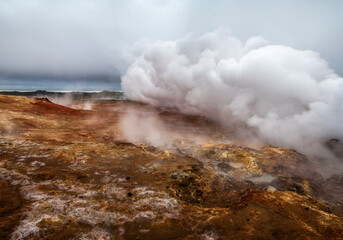 Steam rises from thermal features at Geothermal area in Iceland.