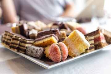 Assorted fruit cakes for holiday. Desserts with fruits, mousse, biscuits