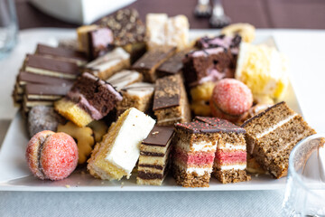 Assorted fruit cakes for holiday. Desserts with fruits, mousse, biscuits