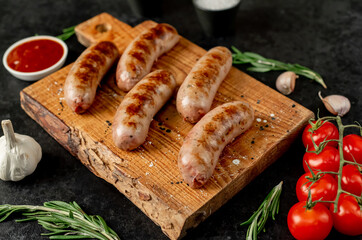 grilled sausages on stone background