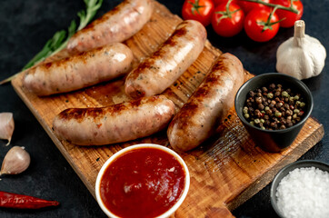 grilled sausages on stone background