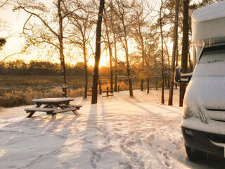 Snow Covered RV Camper at Sunrise - Powered by Adobe