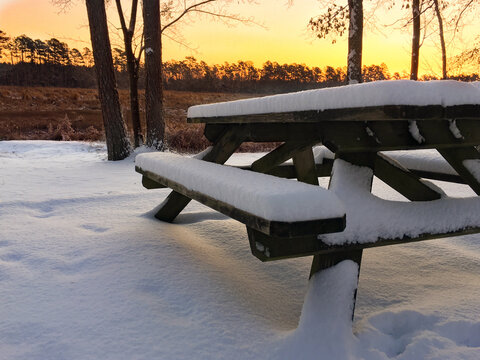 Snow Covered Picnic Table at Sunrise - Powered by Adobe