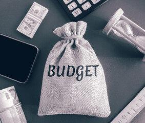 Money bag with the word Budget. Budgeting, forecasting income and optimizing expenses. Planning...