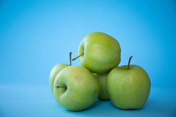 green apples on blue background