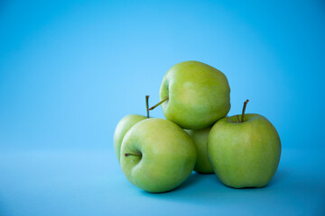 green apples on blue background