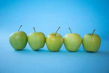 green apples on a blue background