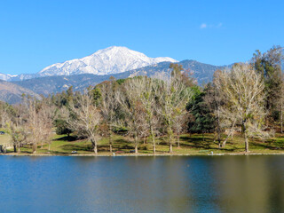 Fototapeta na wymiar A Valley Recreation Lake with a Snow Capped Mountain Summit in the Background In Southern California