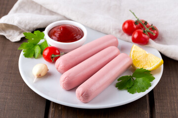 Raw sausages on white plate
