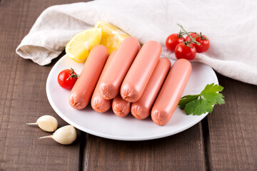 Raw sausages on white plate